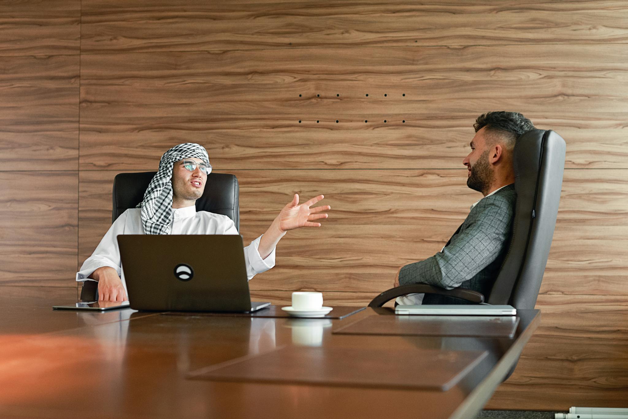Two businessmen having a productive conversation in a modern office setting.
